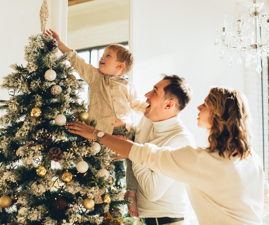 A family decorating a Christmas tree together
