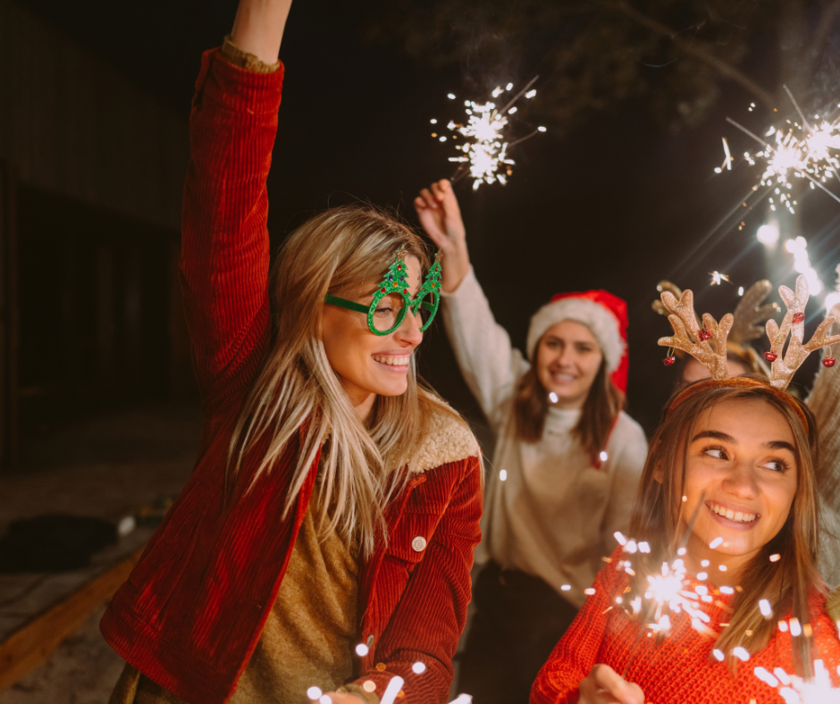 Friends holding sparklers at a Christmas party