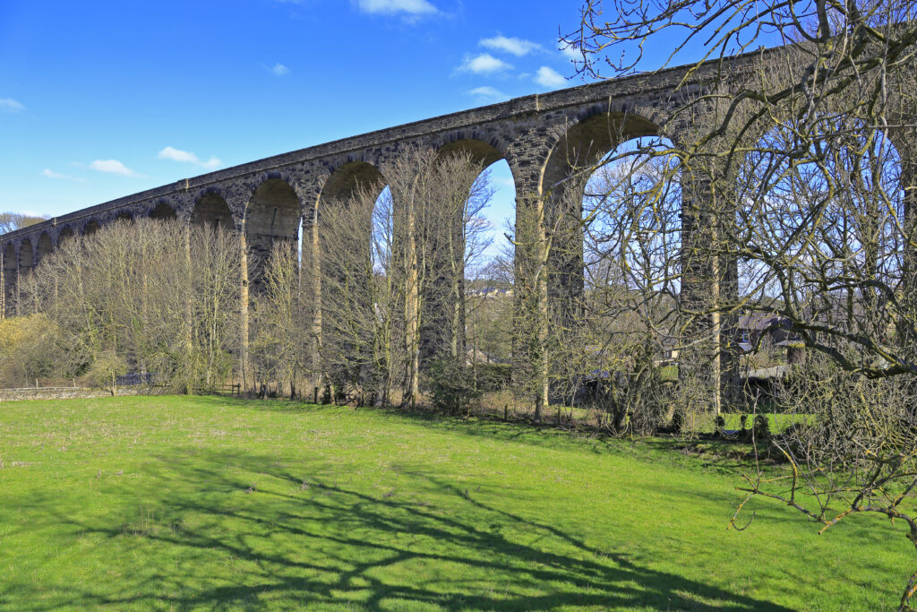 A stone railway viaduct crossing a green valley