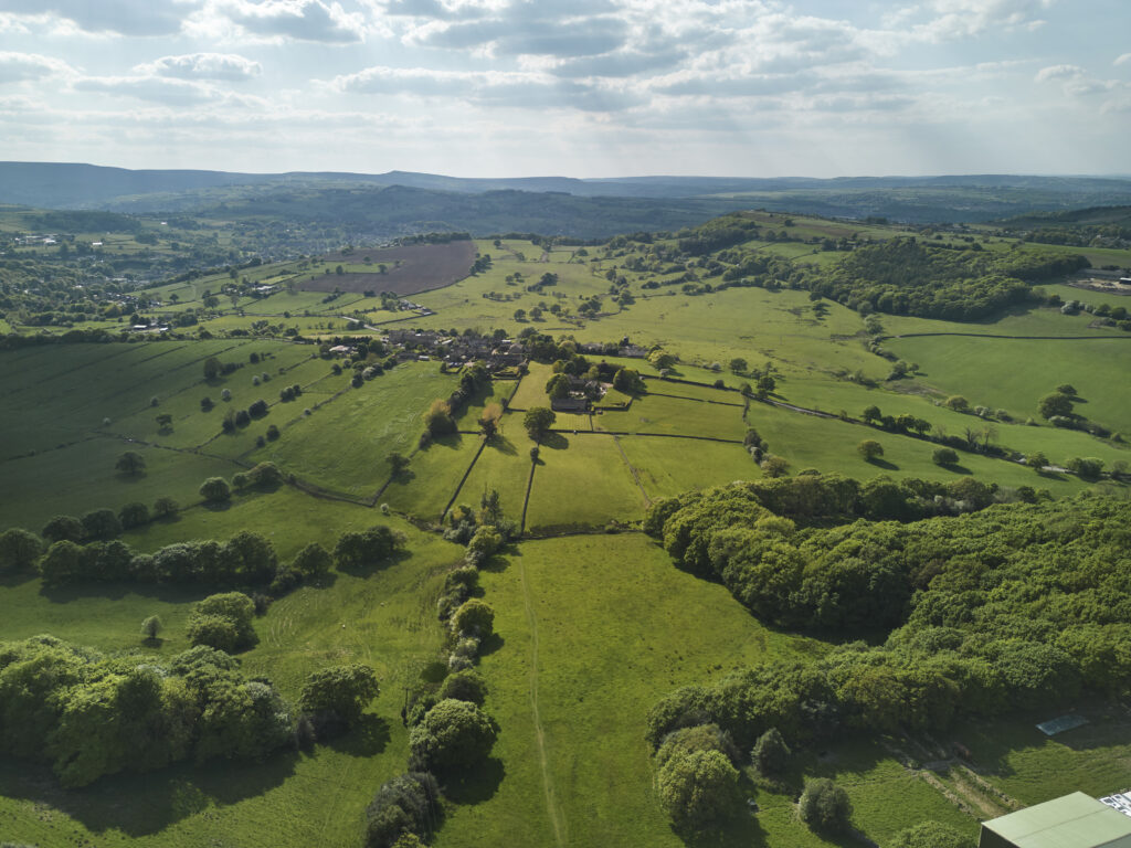 An aerial view of fields and woodland around a Yorkshire village