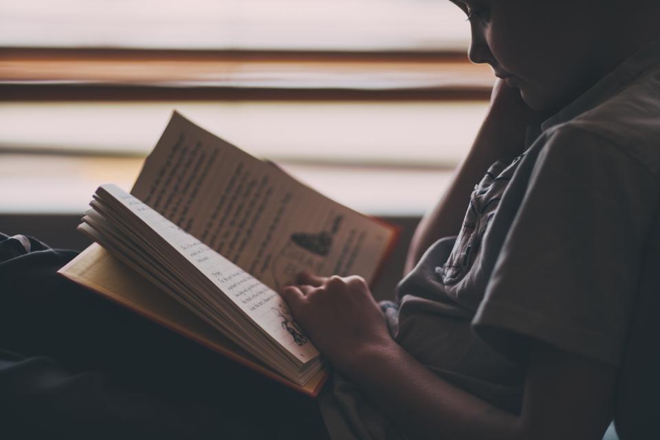 A child sitting reading a book